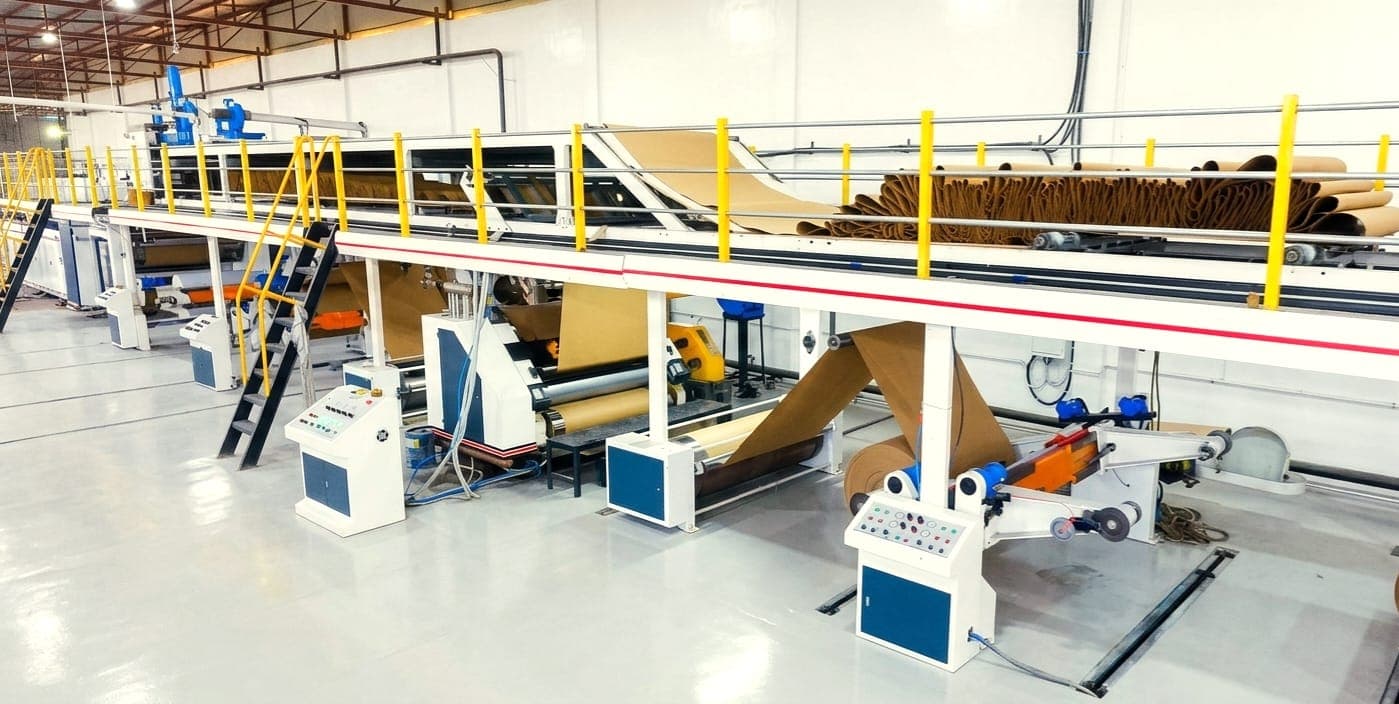 Manufacturing floor at Maharaj Packers โ workers and corrugated box production